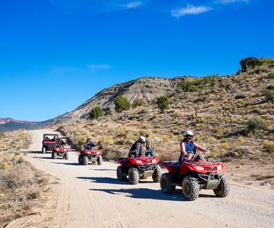 Visitors to Bar 10 Ranch ride ATVs through the desert scenery en route to a scenic overlook